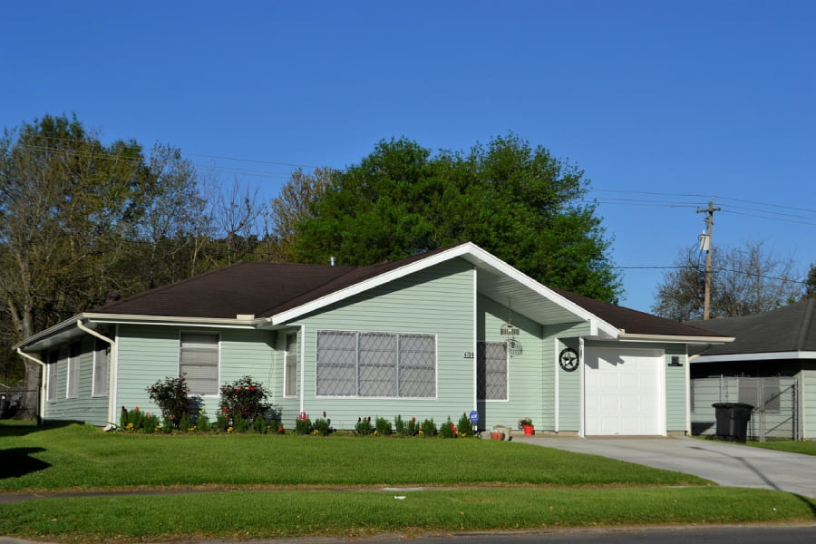 nice green modern ranch styled home with landscaped lawn