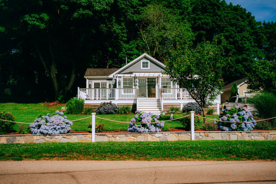 nice green modern ranch styled home with landscaped lawn